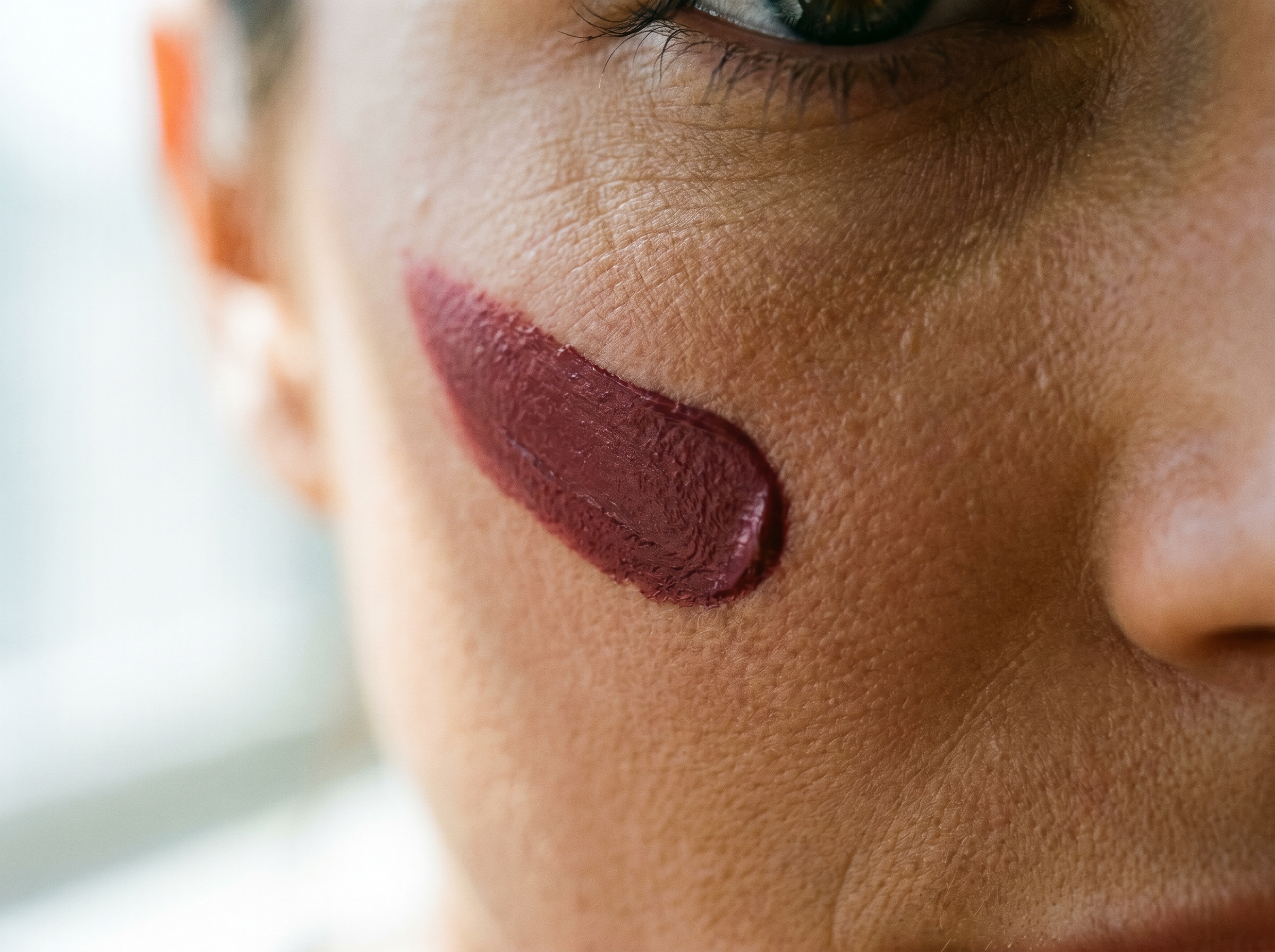 Blush texture macro — a single sweep on the cheekbone.